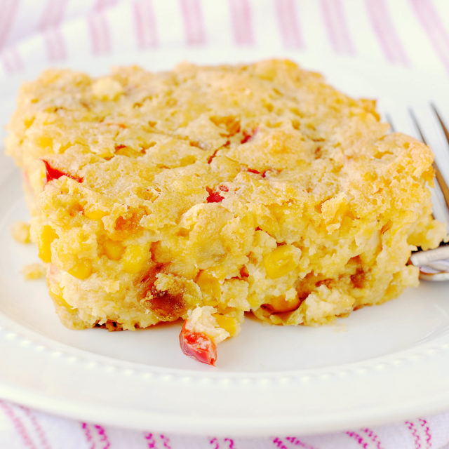 Corn Fritter Casserole - a basic corn casserole gets amped up with the addition of green and red peppers, onion, and sharp cheddar cheese.