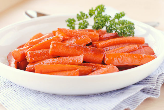 Glazed Carrots - super easy to make. Carrots are sauteed in butter, then sprinkled with brown sugar.